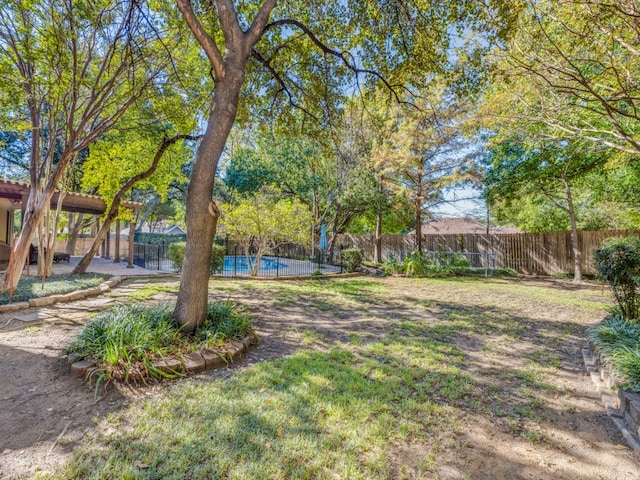 view of yard with a fenced in pool