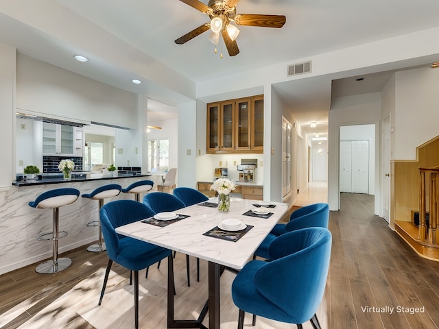 dining space featuring ceiling fan and wood-type flooring