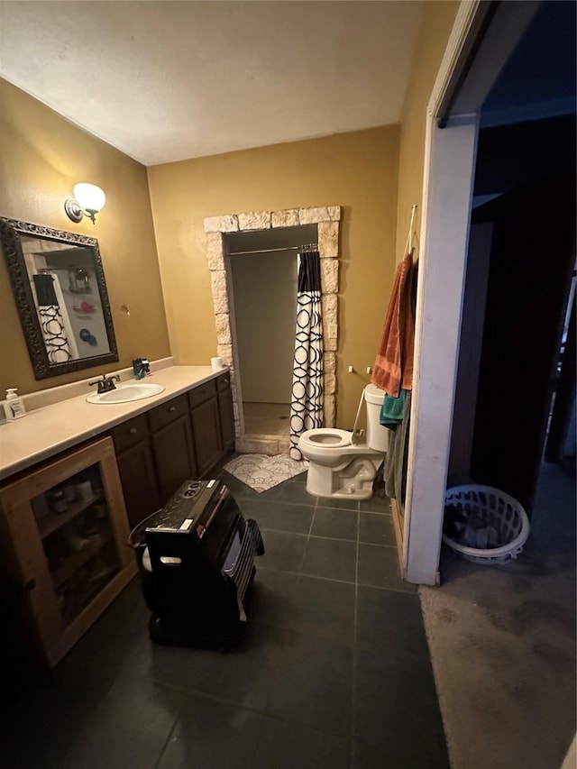 bathroom with vanity, tile patterned floors, and toilet