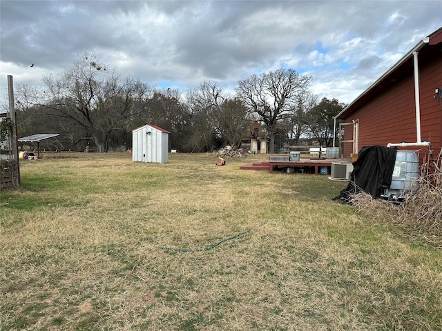 view of yard with cooling unit and a shed