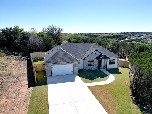 view of front of house featuring a garage and a front lawn