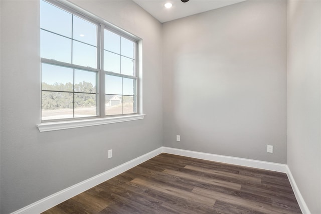 spare room with dark hardwood / wood-style flooring