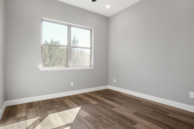 spare room with dark hardwood / wood-style flooring