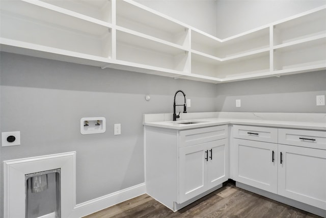 laundry room featuring hookup for a washing machine, electric dryer hookup, sink, and dark hardwood / wood-style floors