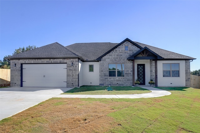 view of front of house featuring a garage and a front yard