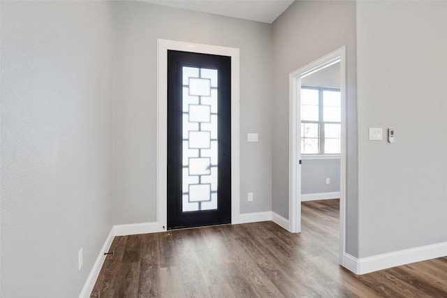 entryway with dark hardwood / wood-style flooring