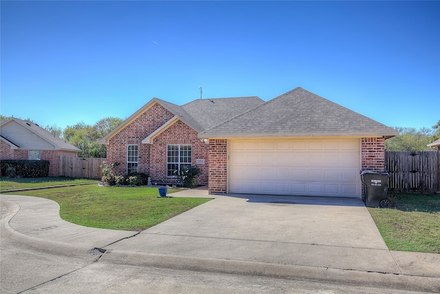 ranch-style house featuring a garage and a front yard