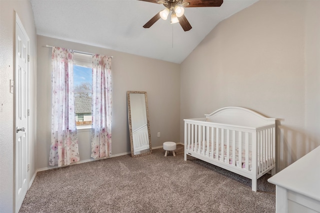 bedroom featuring carpet, a nursery area, lofted ceiling, and ceiling fan