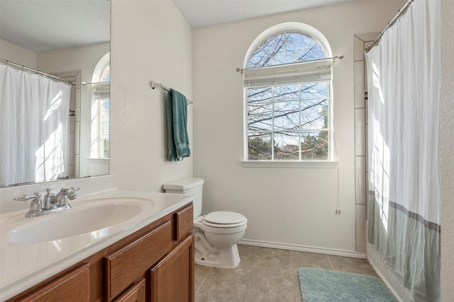 bathroom with vanity, a textured ceiling, a shower with shower curtain, tile patterned flooring, and toilet