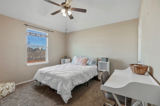 carpeted bedroom with a textured ceiling and ceiling fan