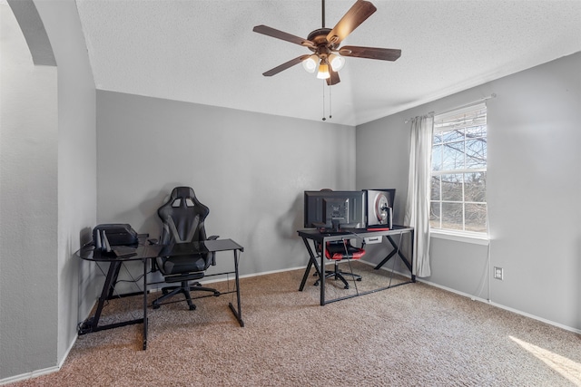 home office featuring ceiling fan, a textured ceiling, and carpet flooring