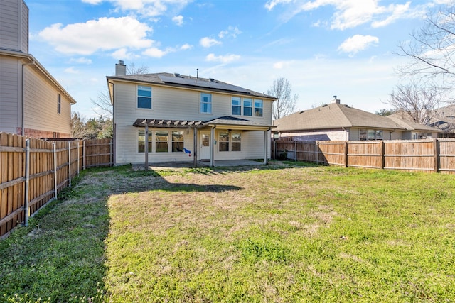 rear view of property with a pergola, a yard, and a patio area