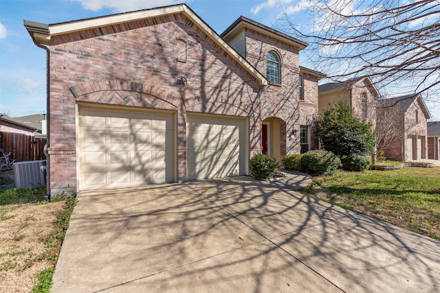 view of front of house with a garage and cooling unit