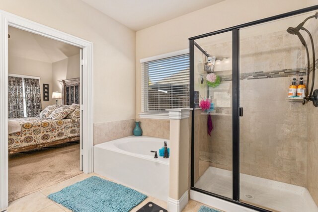 bathroom with shower with separate bathtub and tile patterned floors