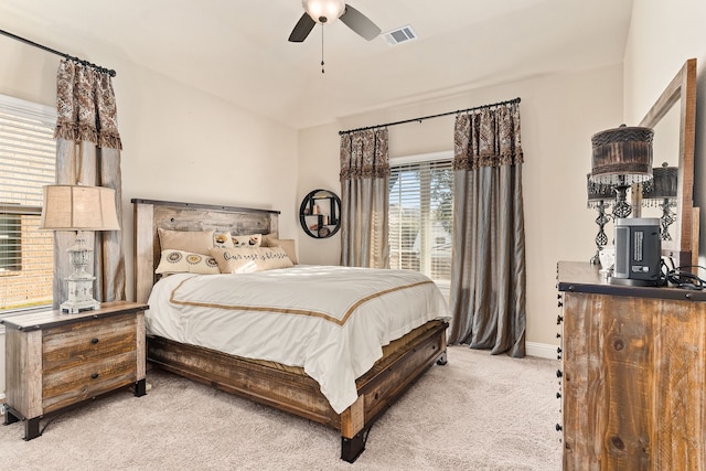 bedroom featuring ceiling fan, light colored carpet, and lofted ceiling