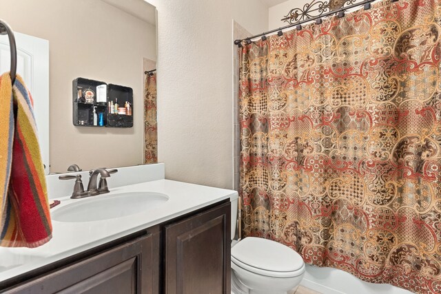 521 Butterfly Blvd, Prosper, TX 75078 - bathroom featuring toilet, vanity, shower / tub combo, and a textured wall