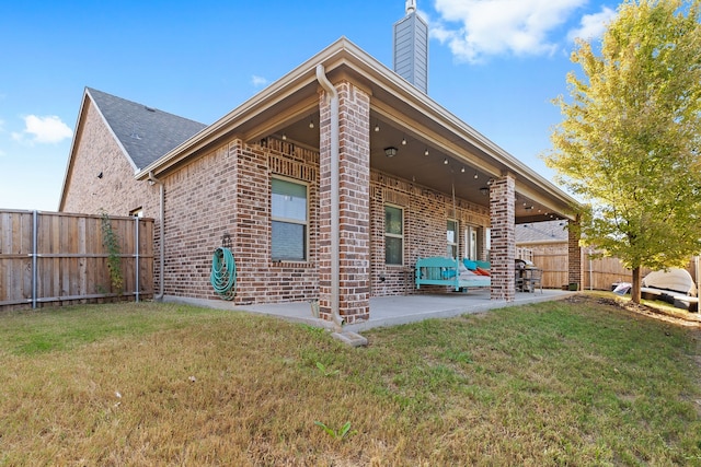 521 Butterfly Blvd, Prosper, TX 75078 - view of side of home with brick siding, a patio, and a chimney