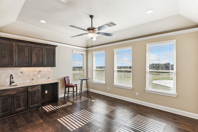 kitchen with dark brown cabinetry, dark hardwood / wood-style floors, and plenty of natural light