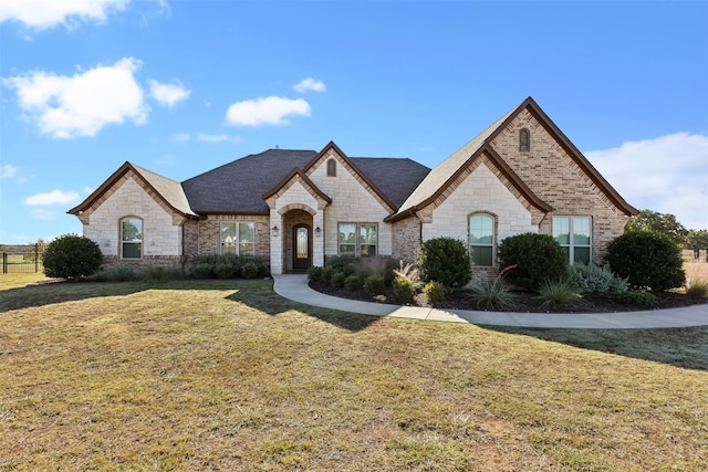 french provincial home with a front lawn