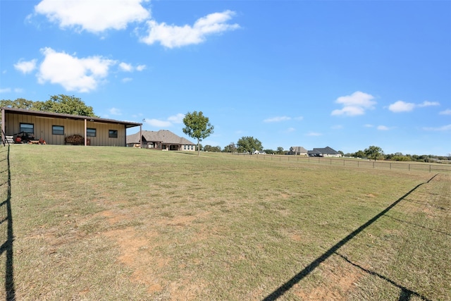 view of yard featuring an outdoor structure and a rural view