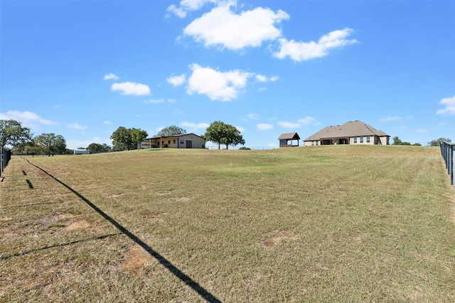 view of yard with a rural view