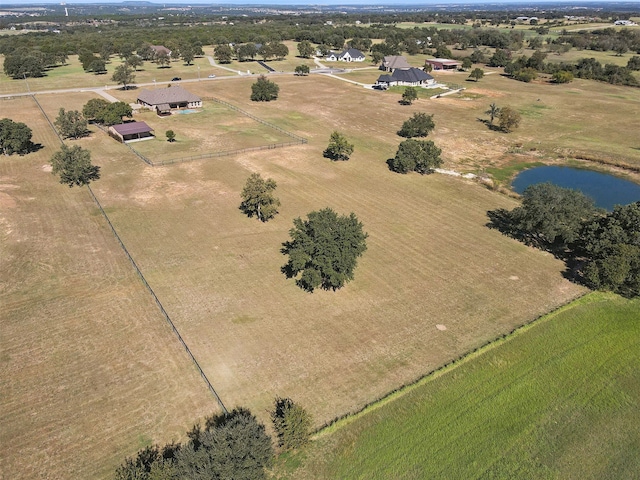 drone / aerial view with a water view and a rural view