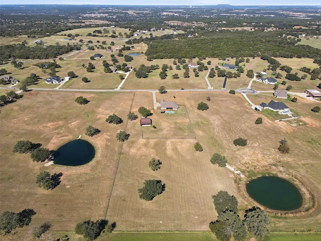 birds eye view of property featuring a rural view and a water view