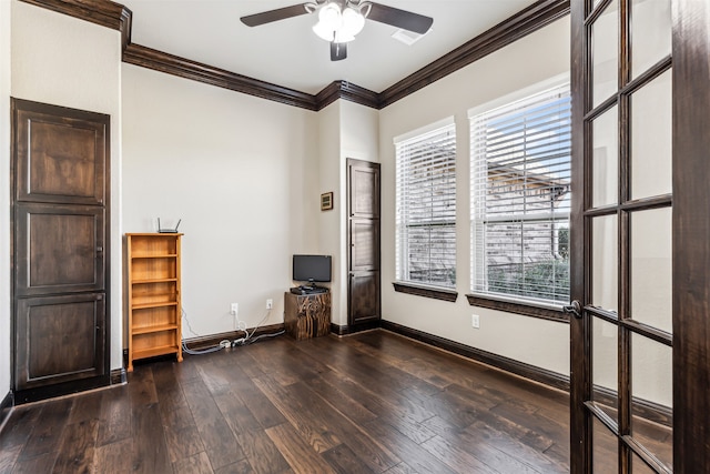 empty room featuring ornamental molding, dark hardwood / wood-style floors, and ceiling fan