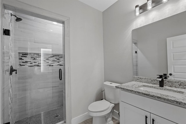 bathroom with toilet, an enclosed shower, and vanity