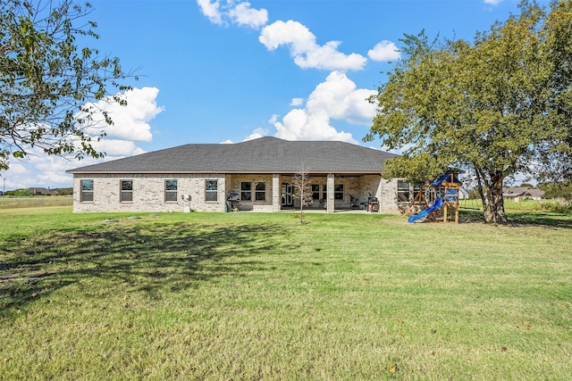 back of property featuring a playground, a patio, and a yard