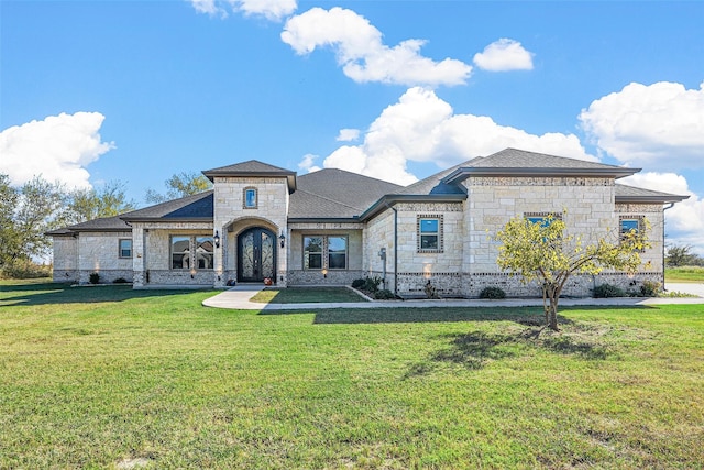 1055 Encino Ct, Wills Point, TX 75169 - french provincial home with stone siding, a front yard, french doors, and roof with shingles