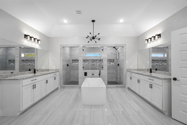 1055 Encino Ct, Wills Point, TX 75169 - bathroom with a shower stall, two vanities, a freestanding bath, and recessed lighting