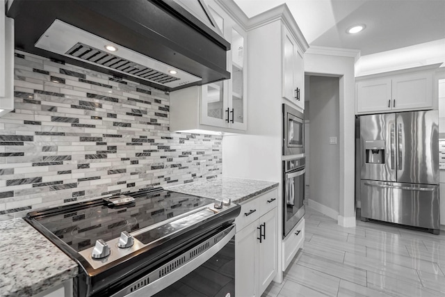 1055 Encino Ct, Wills Point, TX 75169 - kitchen featuring stainless steel appliances, wall chimney exhaust hood, decorative backsplash, white cabinets, and recessed lighting