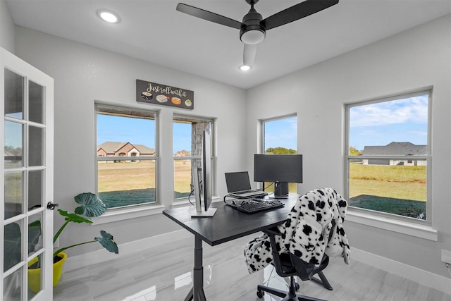 office area featuring hardwood / wood-style floors, ceiling fan, and a healthy amount of sunlight