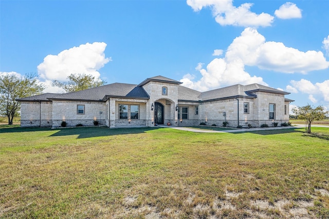 french provincial home with a front yard