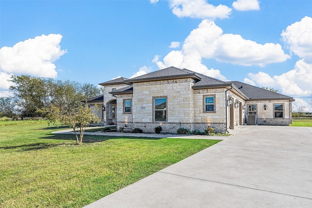 1055 Encino Ct, Wills Point, TX 75169 - french country inspired facade featuring driveway, a front yard, stone siding, an attached garage, and a shingled roof