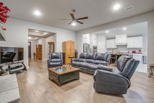 kitchen featuring lofted ceiling, white cabinets, sink, a kitchen island with sink, and a kitchen breakfast bar