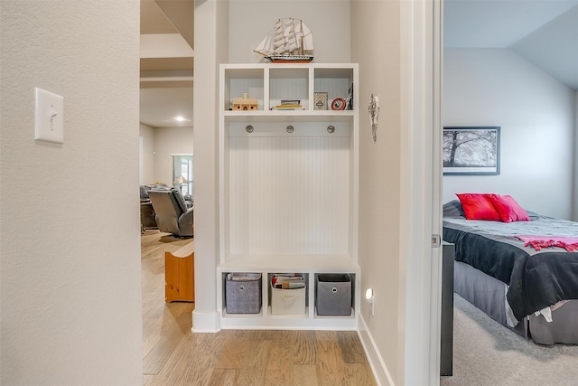 mudroom with light hardwood / wood-style flooring and vaulted ceiling