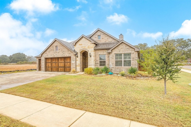 view of front of property featuring a garage and a front yard