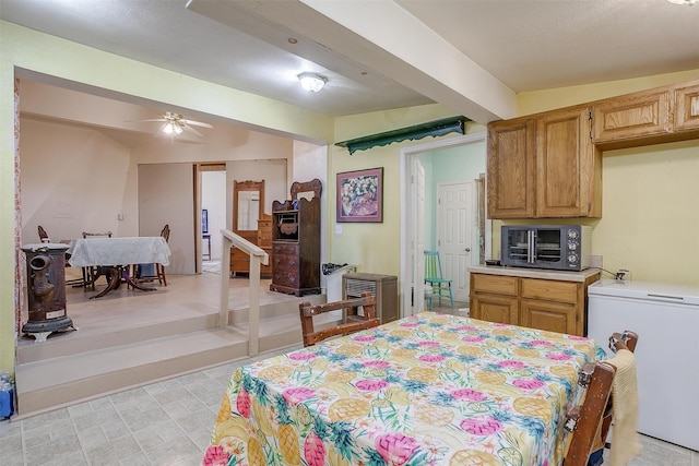 dining area featuring vaulted ceiling with beams and ceiling fan