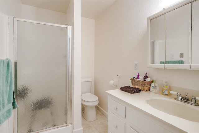 bathroom featuring toilet, vanity, tile patterned flooring, and a shower with door