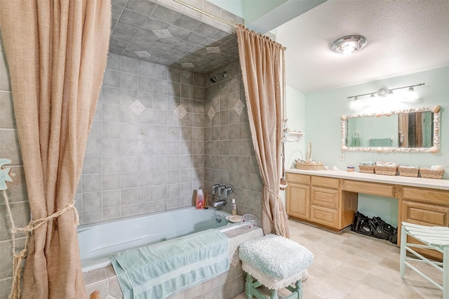 bathroom with shower / tub combo with curtain, vanity, and a textured ceiling