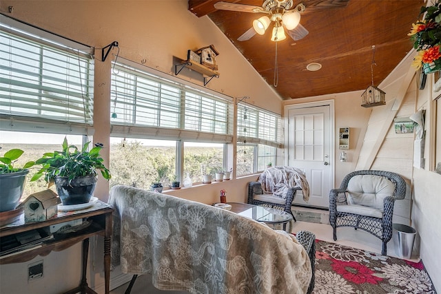 sunroom with lofted ceiling with beams and ceiling fan