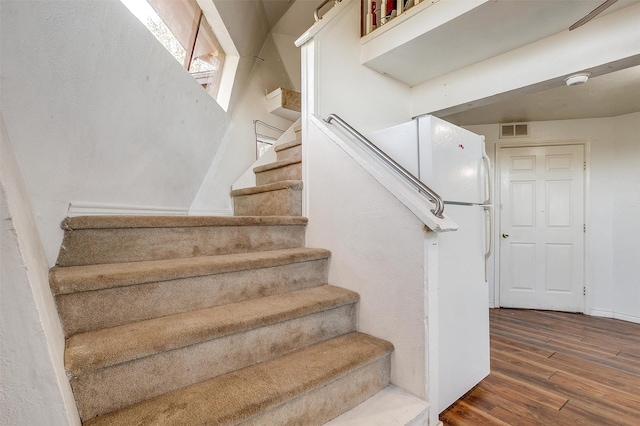 stairway featuring hardwood / wood-style flooring