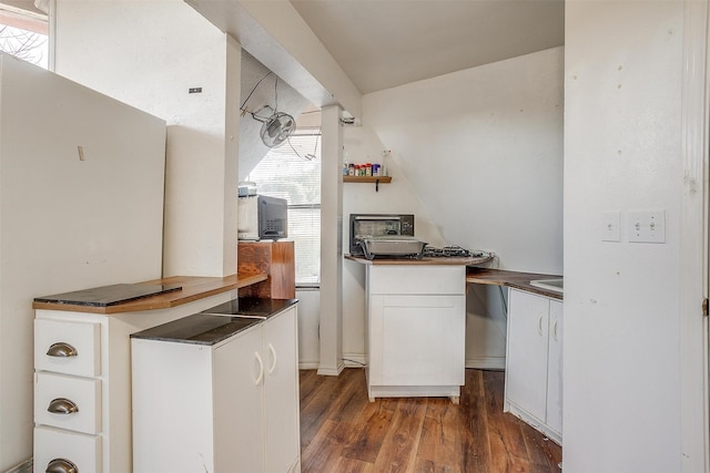 kitchen featuring white cabinets and dark hardwood / wood-style floors