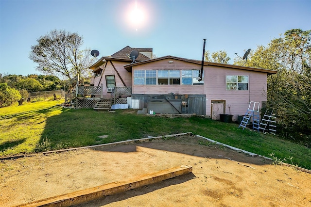 rear view of house featuring a yard