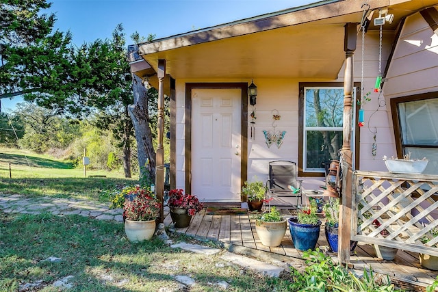 doorway to property with a yard