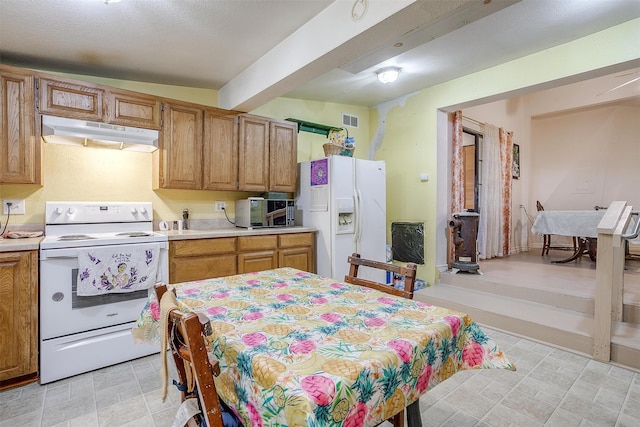 kitchen featuring lofted ceiling with beams and white appliances