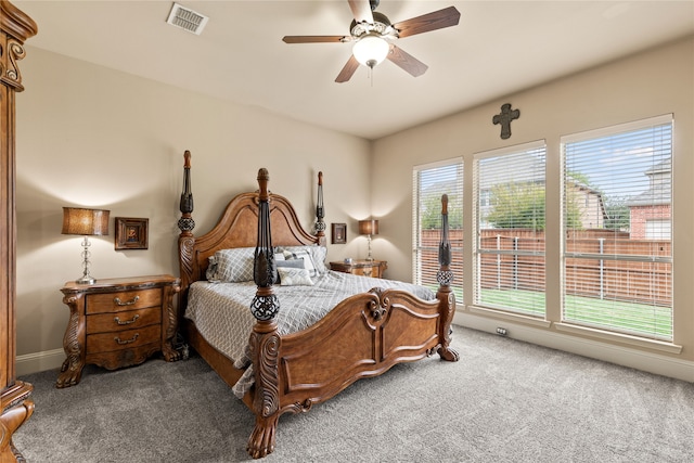 carpeted bedroom with multiple windows and ceiling fan