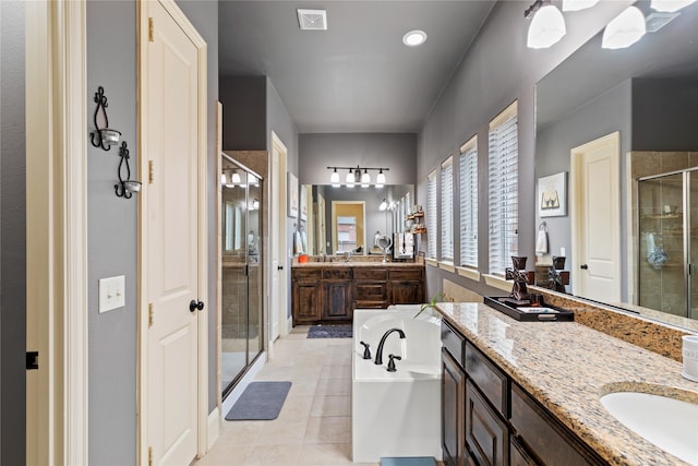 bathroom featuring tile patterned flooring, vanity, and plus walk in shower